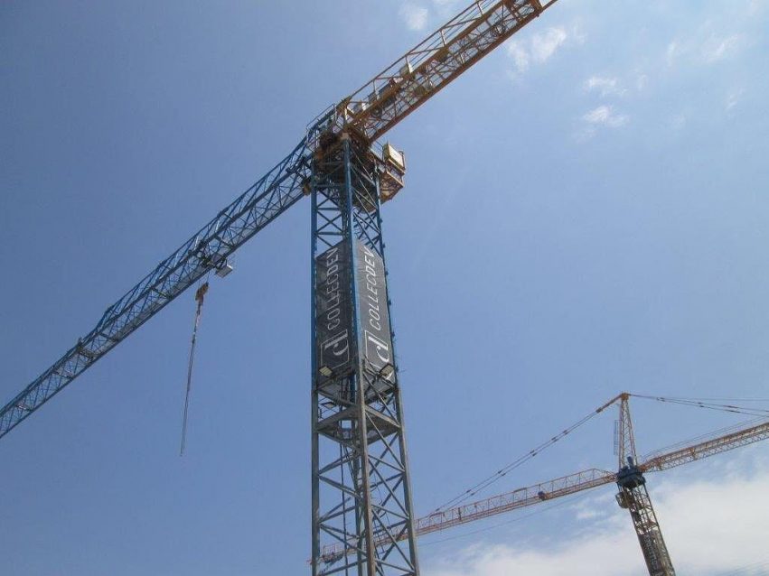 Mesh banner on tower of crane with CollecDev branding