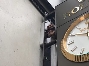 Sign professional reinstalling the Rolex Clock after it has been serviced
